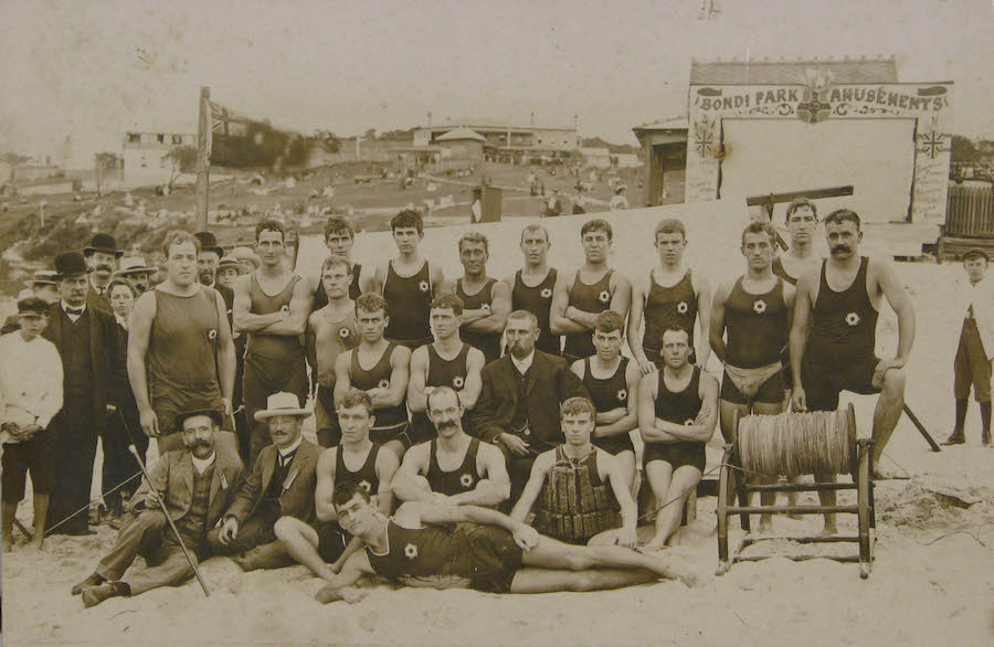 Image 3 of 3 - A black and white photo of a group of men in swimming clothes on a beach