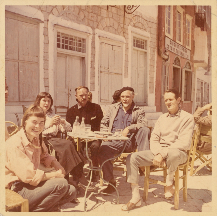 Image 2 of 5 - Group of people sitting in chairs around a table outdoors