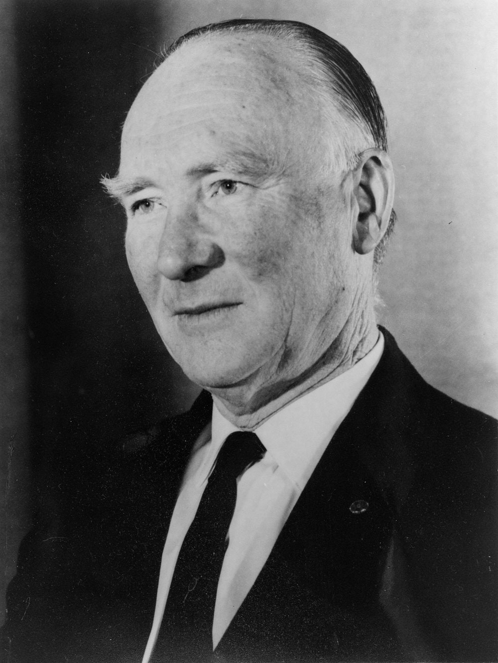 A photograph of Thomas Leech a dark suit and tie.  