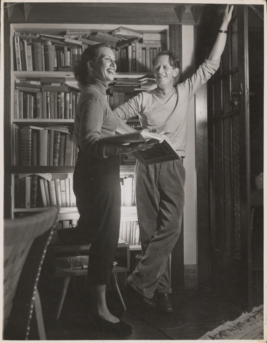 Image 3 of 5 - A man and a woman standing in front of a bookshelf