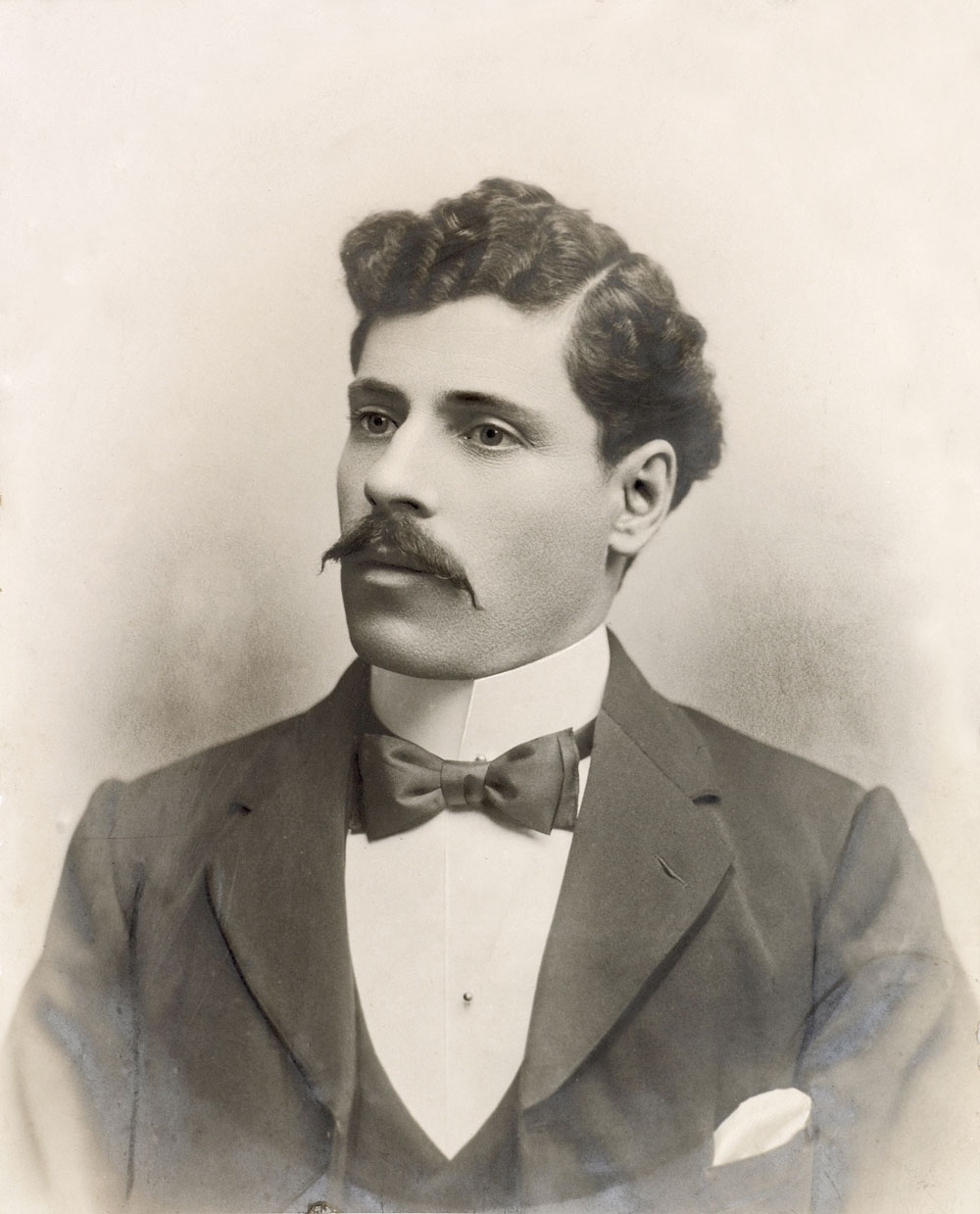 Image 3 of 6 - A formal portrait of Betro Abicare wearing a dark suit and bowtie taken around 1902
