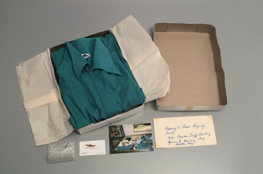 Image 3 of 5 - Image of a blue flying suit, a badge, and related materials.