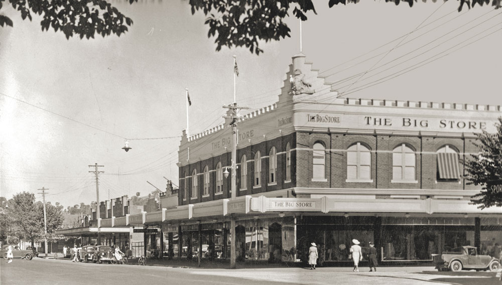 Image 1 of 6 - A photograph of The Big Store on Dean St Albury taken around 1950. Shoppers can be seen entering the building and the name The Big Store can be clearly seen painted on the side and front of the building.