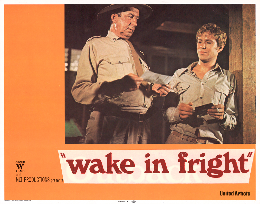 Image 4 of 4 - Orange Lobby Card with the text ‘wake in fright’ beneath a photo of Chips Rafferty and another man. Both are wearing green pants and a button up shirt.