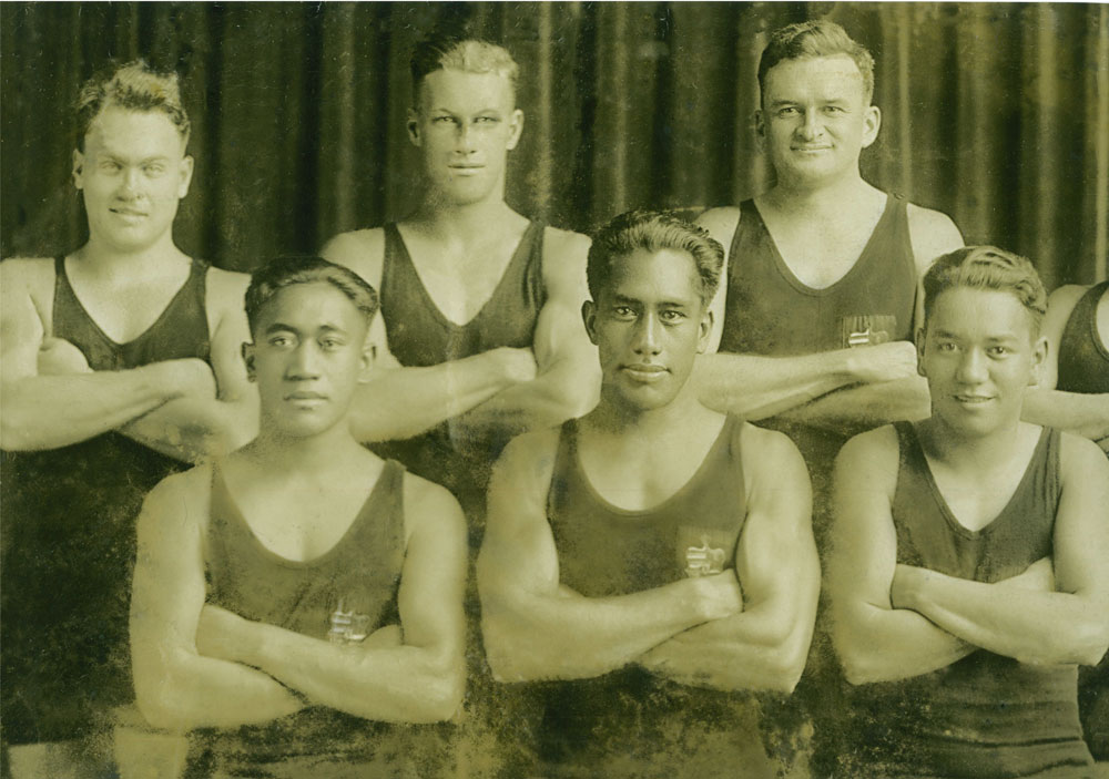 Image 5 of 6 - Formal posed portrait of Duke Kahanamoku (front row, centre) posing with Pua Kealoha to his right, to his left is believed to be George Cunha. The man in the back row over Duke’s left shoulder is “Dad” Centre. The other men in this photo are unknown. Taken during his trip to Australia in 1914-1915