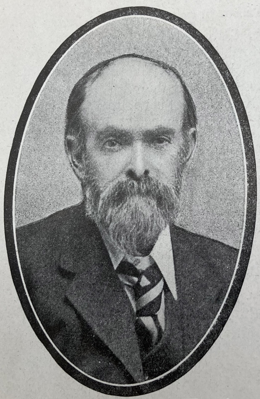 Image 1 of 4 - Black and white portrait of a bearded man wearing a suit.